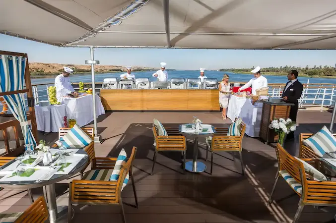 outdoor dining area on Nile cruise with river view